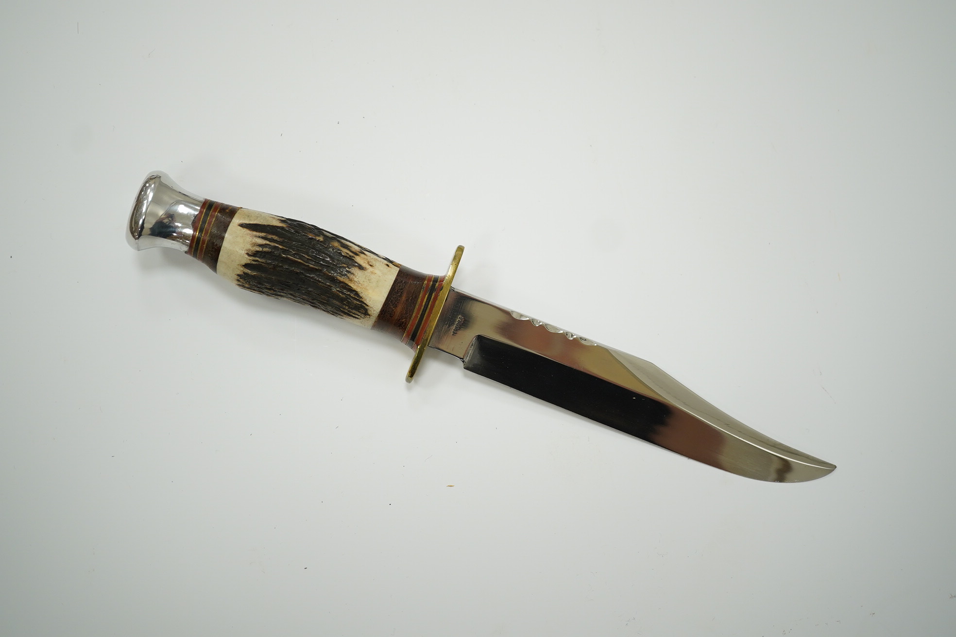 A small bowie knife by R. Cooper in its leather sheath, blade 15cm. Condition - good